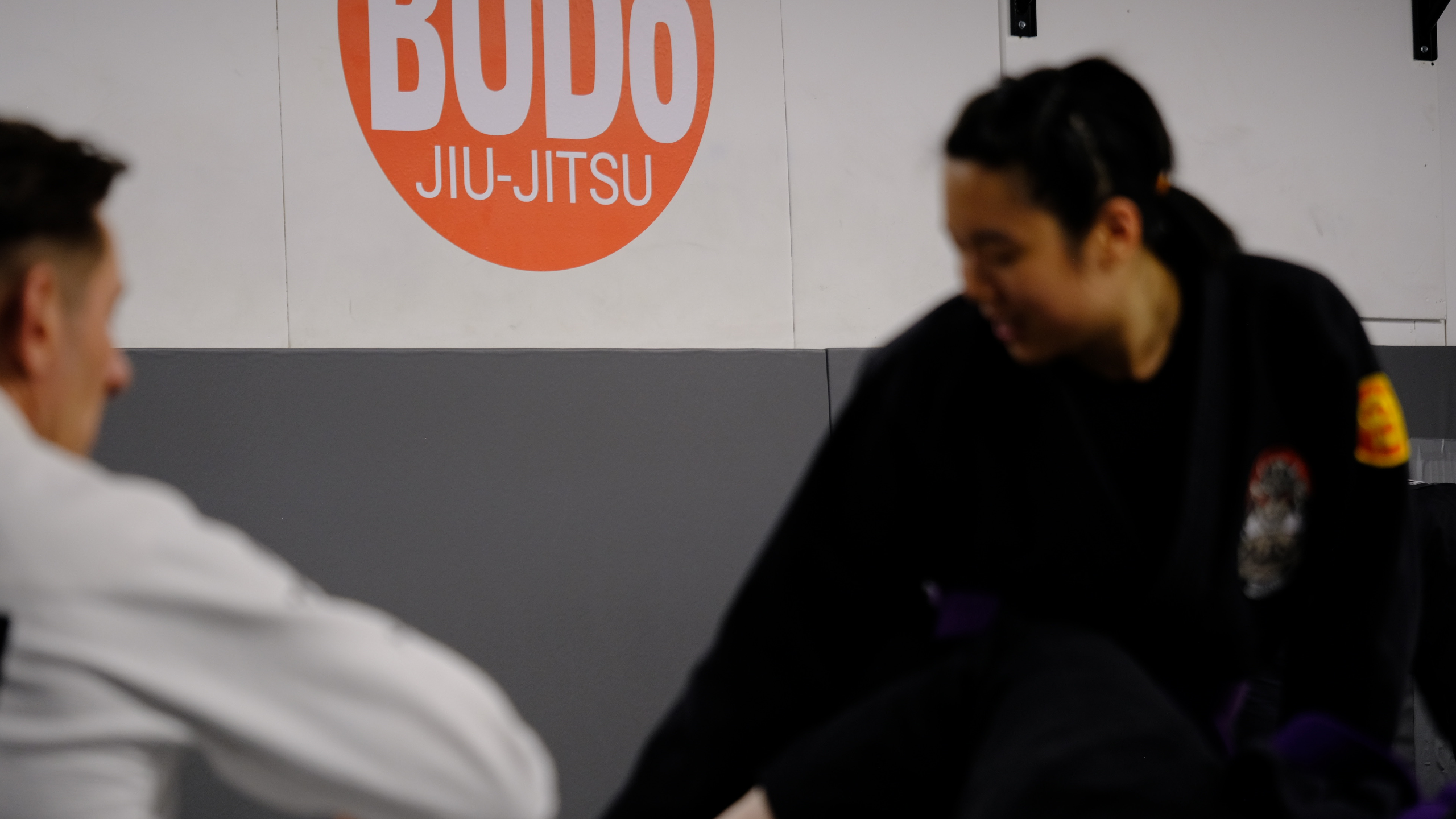 Two women training Brazilian Jiu-Jitsu at Budo Northwest Jiu-Jitsu Academy in Vancouver